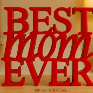 Red wooden “Best Mom Ever” decorative showpiece by MK Crafts displayed on a table with plant décor – handcrafted mother gift item.