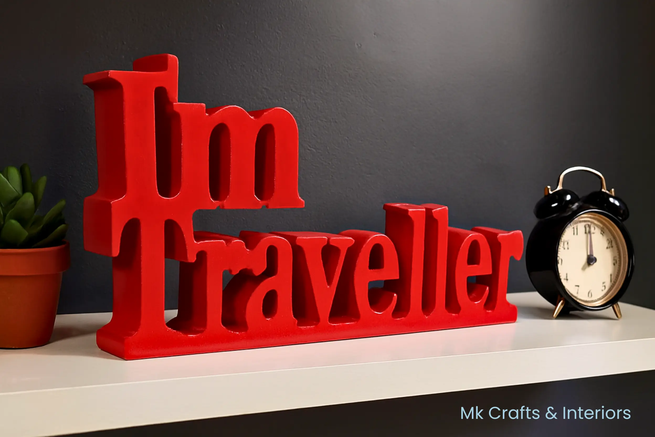 Red “I’m Traveller” wooden decorative showpiece by MK Crafts & Interiors Hyderabad placed on tabletop – bold travel décor gift.