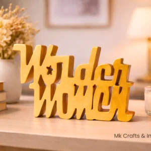 Gold Wonder Woman wooden decorative showpiece for home décor by MK Crafts & Interiors Hyderabad placed on table with candle and books.