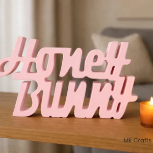 Light pink “Honey Bunny” wooden decorative showpiece by MK Crafts & Interiors Hyderabad displayed on shelf.