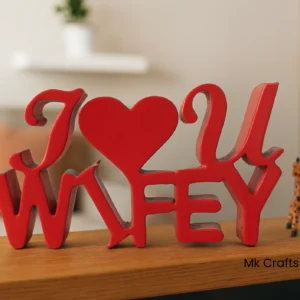 Red “I Love U Wifey” wooden decorative showpiece by MK Crafts & Interiors Hyderabad placed on tabletop – romantic gift home décor item.