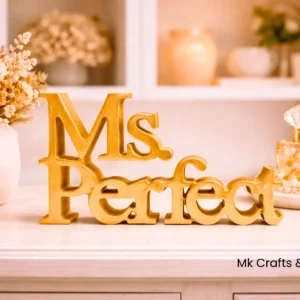 Gold “Ms Perfect” wooden decorative showpiece by MK Crafts & Interiors Hyderabad – premium luxury décor gift item.